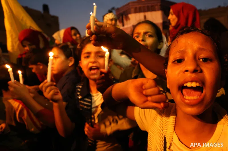 Palestinian children hold candles during a protest against Israel's newly-installed security measures at the entrance to the al-Aqsa mosque compound, in Khan Younis in the southern Gaza Strip July 23, 2017. Photo by Ashr...