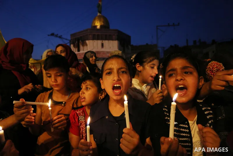 Palestinian children hold candles during a protest against Israel's newly-installed security measures at the entrance to the al-Aqsa mosque compound, in Khan Younis in the southern Gaza Strip July 23, 2017. Photo by Ashr...