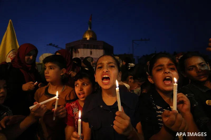 Palestinian children hold candles during a protest against Israel's newly-installed security measures at the entrance to the al-Aqsa mosque compound, in Khan Younis in the southern Gaza Strip July 23, 2017. Photo by Ashr...