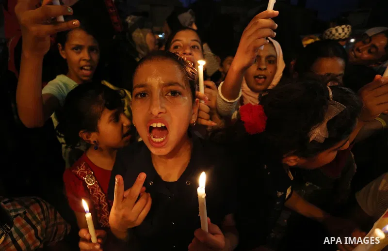 Palestinian children hold candles during a protest against Israel's newly-installed security measures at the entrance to the al-Aqsa mosque compound, in Khan Younis in the southern Gaza Strip July 23, 2017. Photo by Ashr...