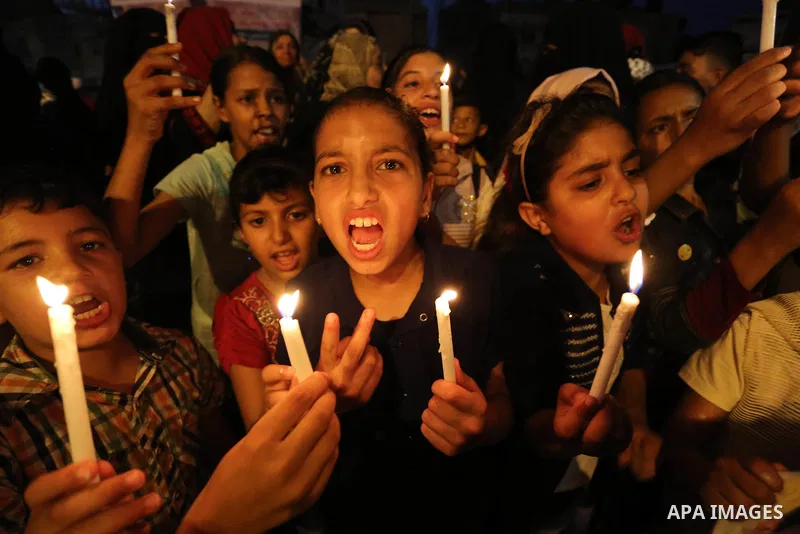 Palestinian children hold candles during a protest against Israel's newly-installed security measures at the entrance to the al-Aqsa mosque compound, in Khan Younis in the southern Gaza Strip July 23, 2017. Photo by Ashr...