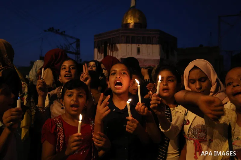 Palestinian children hold candles during a protest against Israel's newly-installed security measures at the entrance to the al-Aqsa mosque compound, in Khan Younis in the southern Gaza Strip July 23, 2017. Photo by Ashr...