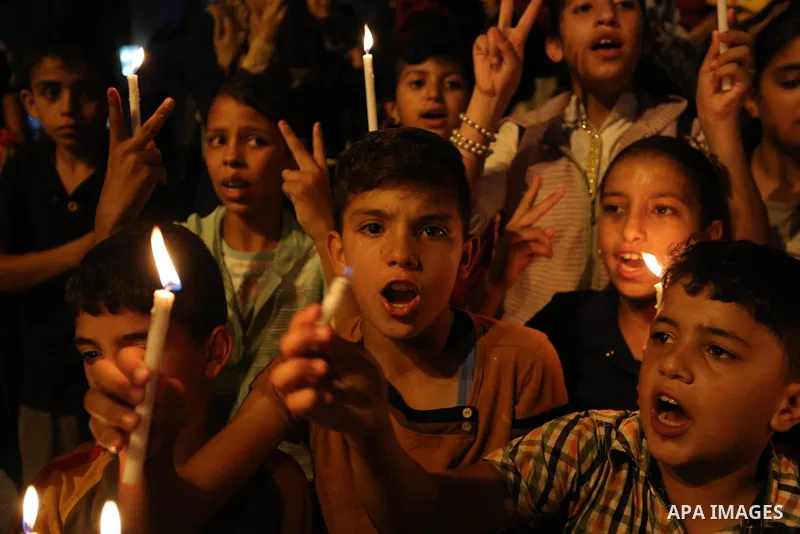Palestinian children hold candles during a protest against Israel's newly-installed security measures at the entrance to the al-Aqsa mosque compound, in Khan Younis in the southern Gaza Strip July 23, 2017. Photo by Ashr...
