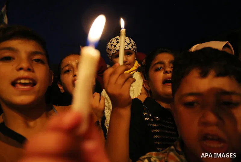 Palestinian children hold candles during a protest against Israel's newly-installed security measures at the entrance to the al-Aqsa mosque compound, in Khan Younis in the southern Gaza Strip July 23, 2017. Photo by Ashr...