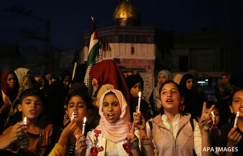 Palestinian children hold candles during a protest against Israel's newly-installed security measures at the entrance to the al-Aqsa mosque compound, in Khan Younis in the southern Gaza Strip July 23, 2017. Photo by Ashr...