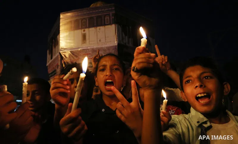 Palestinian children hold candles during a protest against Israel's newly-installed security measures at the entrance to the al-Aqsa mosque compound, in Khan Younis in the southern Gaza Strip July 23, 2017. Photo by Ashr...