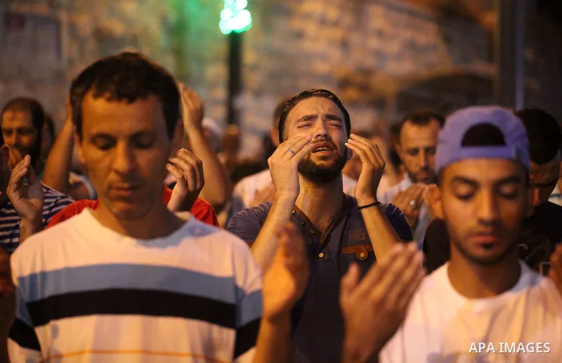 Palestinian Muslim worshippers pray outside Lions' Gate, a main entrance to the Al-Aqsa mosque compound in Jerusalem's Old City, on July 24, 2017, in protest against new Israeli security measures implemented at the holy...