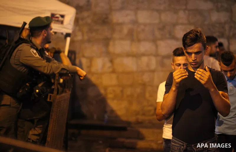 Palestinian Muslim worshippers pray outside Lions' Gate, a main entrance to the Al-Aqsa mosque compound in Jerusalem's Old City, on July 24, 2017, in protest against new Israeli security measures implemented at the holy...