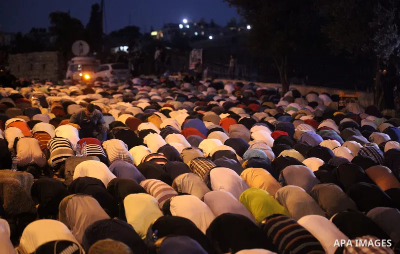 Palestinian Muslim worshippers pray outside Lions' Gate, a main entrance to the Al-Aqsa mosque compound in Jerusalem's Old City, on July 24, 2017, in protest against new Israeli security measures implemented at the holy...