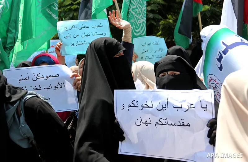 Palestinian protesters shout slogans and hold placards during a demonstration against Israeli security measures that were implemented at the Al-Aqsa mosque compound in Jerusalem the previous week prior to being removed a...