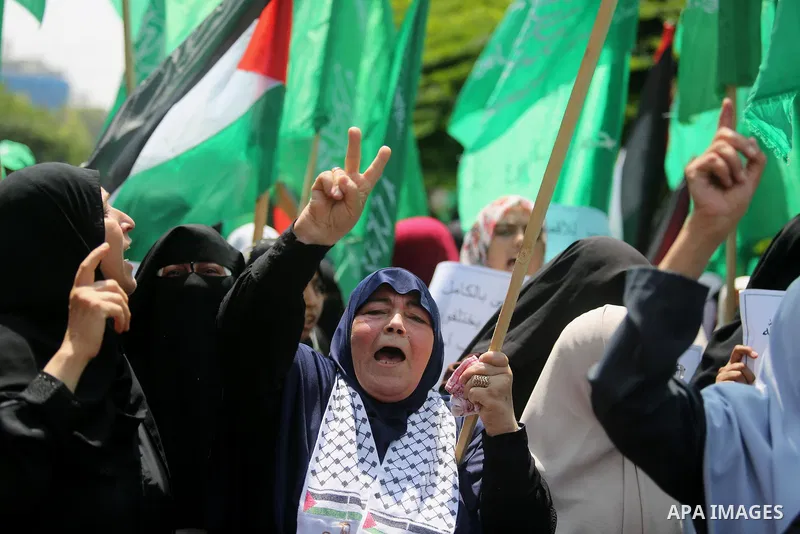 Palestinian protesters shout slogans and hold placards during a demonstration against Israeli security measures that were implemented at the Al-Aqsa mosque compound in Jerusalem the previous week prior to being removed a...