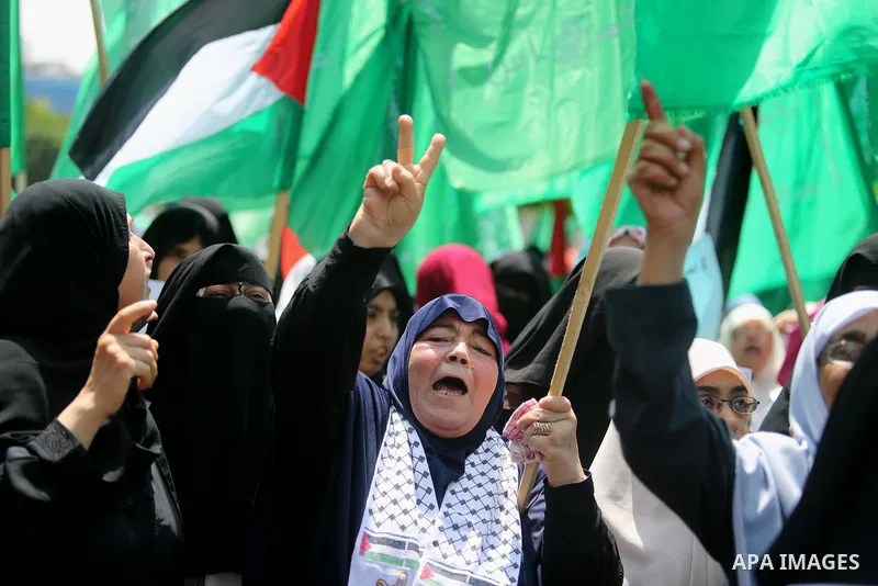 Palestinian protesters shout slogans and hold placards during a demonstration against Israeli security measures that were implemented at the Al-Aqsa mosque compound in Jerusalem the previous week prior to being removed a...