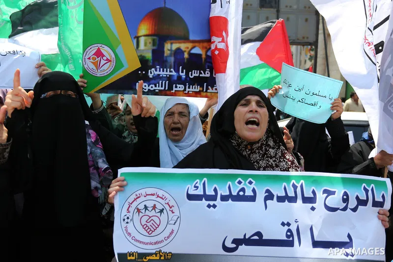 Palestinian protesters shout slogans and hold placards during a demonstration against Israeli security measures that were implemented at the Al-Aqsa mosque compound in Jerusalem the previous week prior to being removed a...