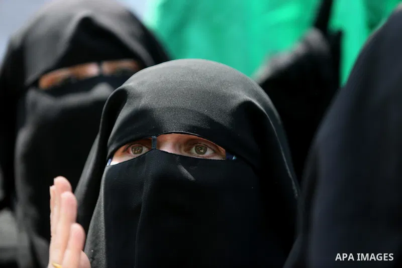 A masked female protester takes part during a demonstration against Israeli security measures that were implemented at the Al-Aqsa mosque compound in Jerusalem the previous week prior to being removed after their install...