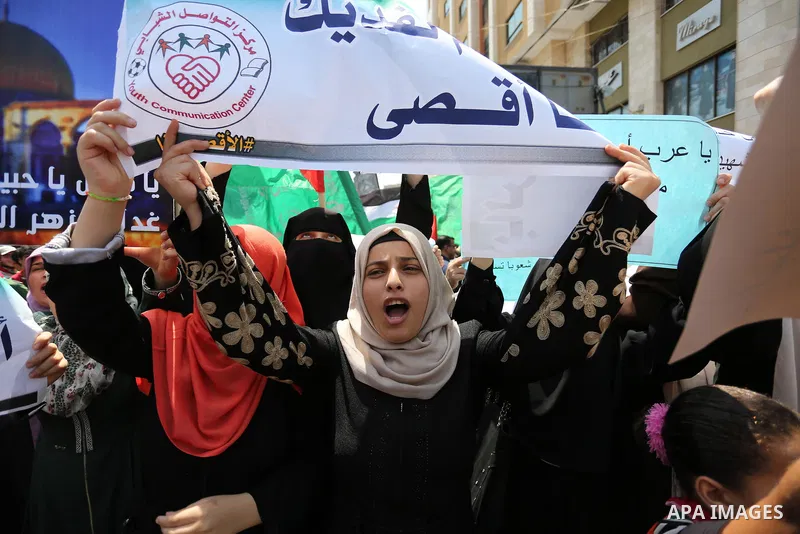 Palestinian protesters shout slogans and hold placards during a demonstration against Israeli security measures that were implemented at the Al-Aqsa mosque compound in Jerusalem the previous week prior to being removed a...