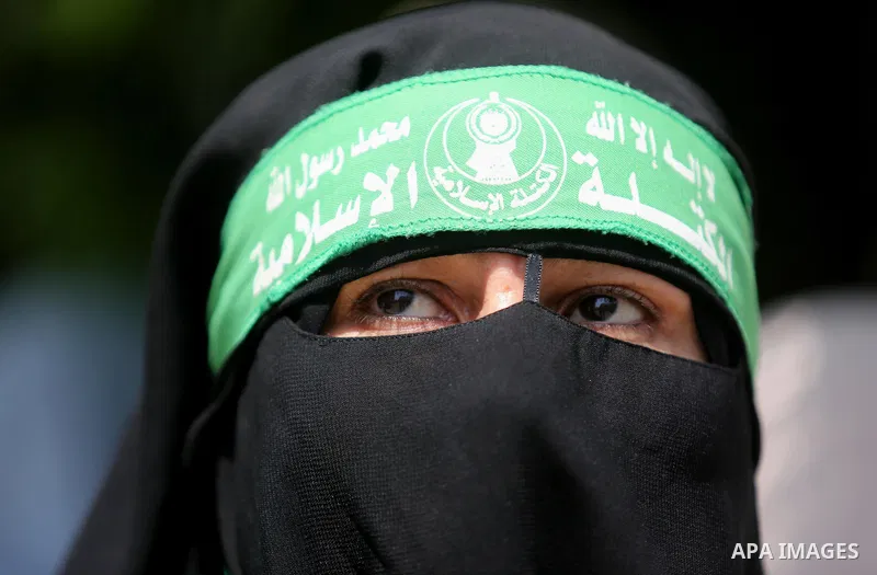A masked female protester takes part during a demonstration against Israeli security measures that were implemented at the Al-Aqsa mosque compound in Jerusalem the previous week prior to being removed after their install...