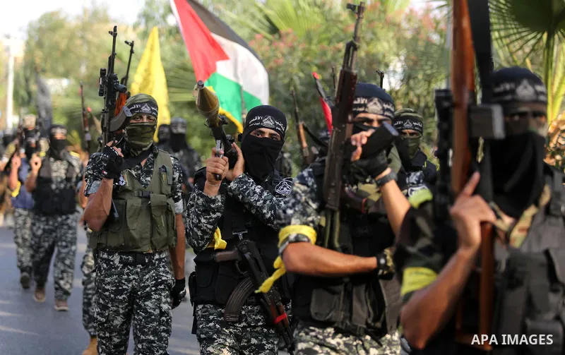 Palestinian militants from different local factions take part in a military parade against Israel in Gaza City on July 25, 2017. Photo by Ashraf Amra