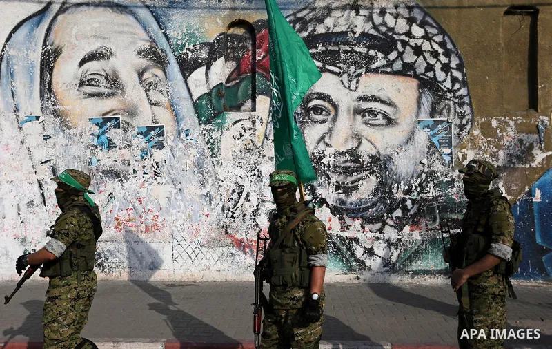 Palestinian militants from different local factions take part in a military parade against Israel in Gaza City on July 25, 2017. Photo by Ashraf Amra