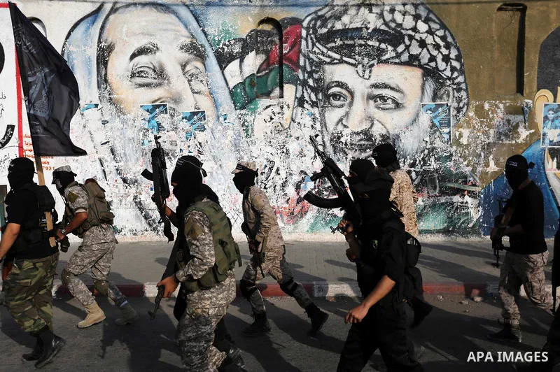 Palestinian militants from different local factions take part in a military parade against Israel in Gaza City on July 25, 2017. Photo by Ashraf Amra