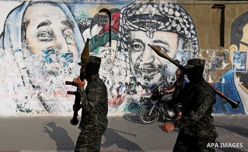 Palestinian militants from different local factions take part in a military parade against Israel in Gaza City on July 25, 2017. Photo by Ashraf Amra