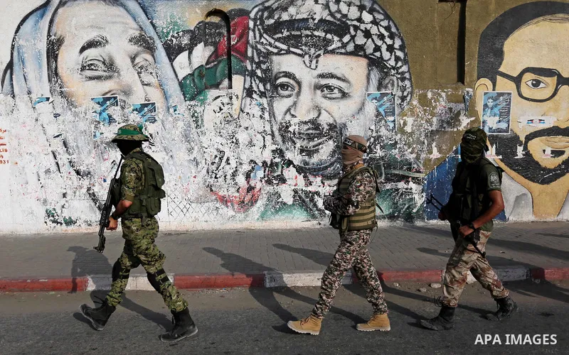 Palestinian militants from different local factions take part in a military parade against Israel in Gaza City on July 25, 2017. Photo by Ashraf Amra