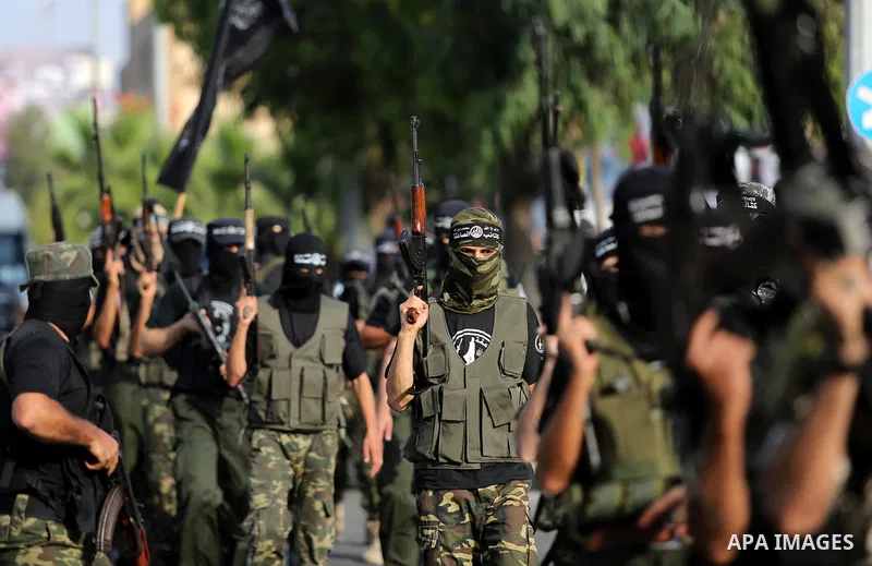 Palestinian militants from different local factions take part in a military parade against Israel in Gaza City on July 25, 2017. Photo by Ashraf Amra