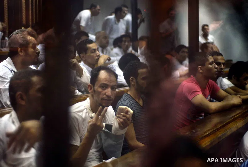 Egyptian defendants sits behind the defendant's bars during their trial at "Cabinet Incidents" case at the court in Cairo, Egypt, on July 25, 2017. An Egyptian criminal court sentenced 43 activists to life in prison on T...