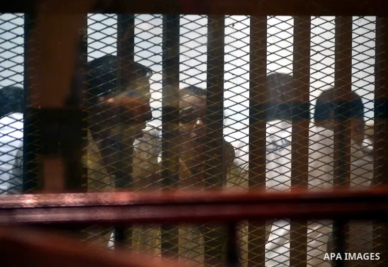 Egyptian defendants sits behind the defendant's bars during their trial at "Cabinet Incidents" case at the court in Cairo, Egypt, on July 25, 2017. An Egyptian criminal court sentenced 43 activists to life in prison on T...