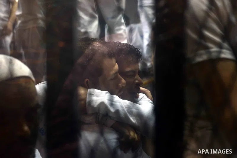 Egyptian defendants sits behind the defendant's bars during their trial at "Cabinet Incidents" case at the court in Cairo, Egypt, on July 25, 2017. An Egyptian criminal court sentenced 43 activists to life in prison on T...