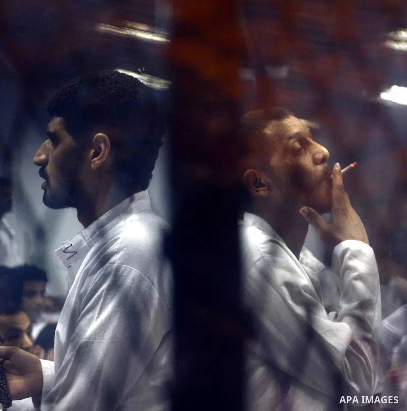 Egyptian defendants sits behind the defendant's bars during their trial at "Cabinet Incidents" case at the court in Cairo, Egypt, on July 25, 2017. An Egyptian criminal court sentenced 43 activists to life in prison on T...
