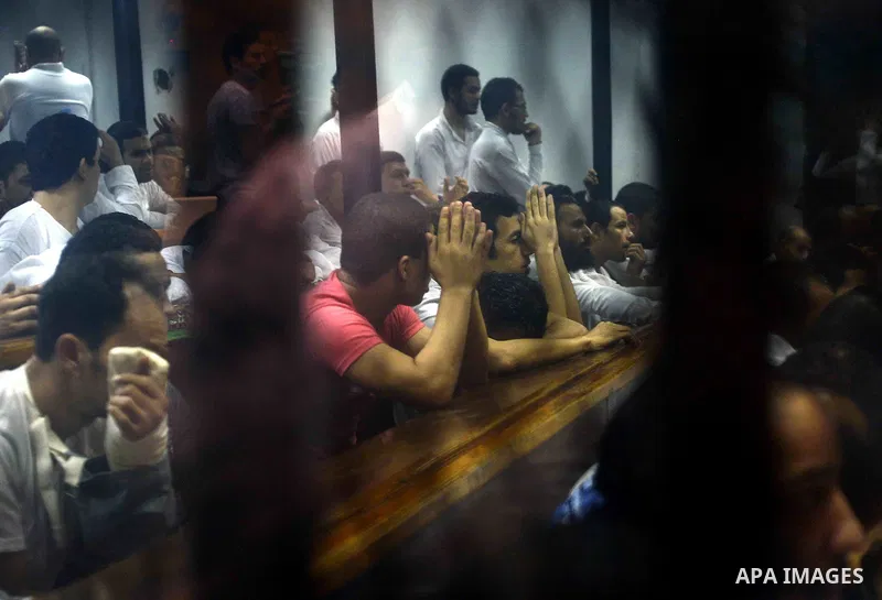 Egyptian defendants sits behind the defendant's bars during their trial at "Cabinet Incidents" case at the court in Cairo, Egypt, on July 25, 2017. An Egyptian criminal court sentenced 43 activists to life in prison on T...