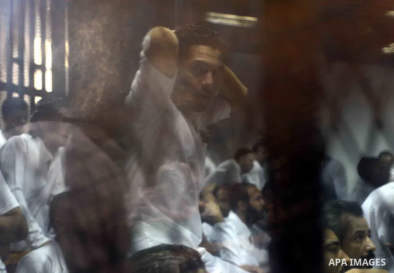 Egyptian defendants sits behind the defendant's bars during their trial at "Cabinet Incidents" case at the court in Cairo, Egypt, on July 25, 2017. An Egyptian criminal court sentenced 43 activists to life in prison on T...