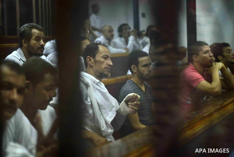 Egyptian defendants sits behind the defendant's bars during their trial at "Cabinet Incidents" case at the court in Cairo, Egypt, on July 25, 2017. An Egyptian criminal court sentenced 43 activists to life in prison on T...