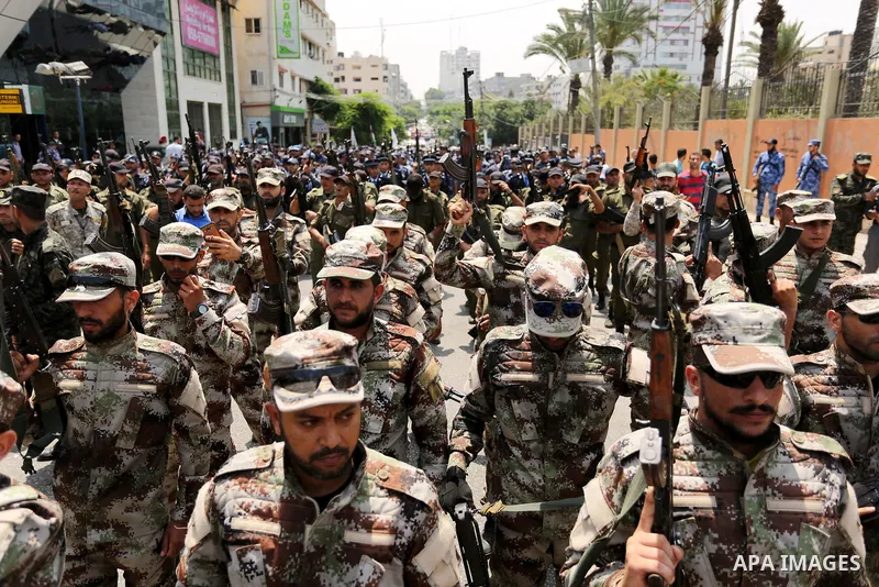 Members of Palestinian forces in Gaza strip take part in a military parade in Gaza City on July 26, 2017 as a tense standoff is underway between Israel and Muslim worshippers at Jerusalem's Al-Aqsa compound. Muslims have...