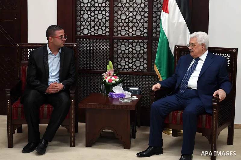 Palestinian President Mahmoud Abbas meets with a Palestinian Christian Nidal Aboud, who prays alongside Palestinian Muslims in Jerusalem, at his office in the West Bank city of Ramallah, on July 26, 2017. Photo by Thaer...