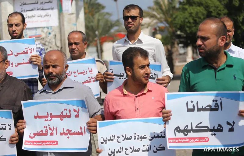 Palestinians take part in a protest against Israel's newly-installed security measures at the entrance to the al-Aqsa mosque compound, in Gaza city on July 27, 2017. Photo by Mohammed Asad