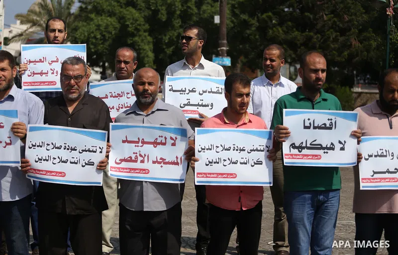 Palestinians take part in a protest against Israel's newly-installed security measures at the entrance to the al-Aqsa mosque compound, in Gaza city on July 27, 2017. Photo by Mohammed Asad