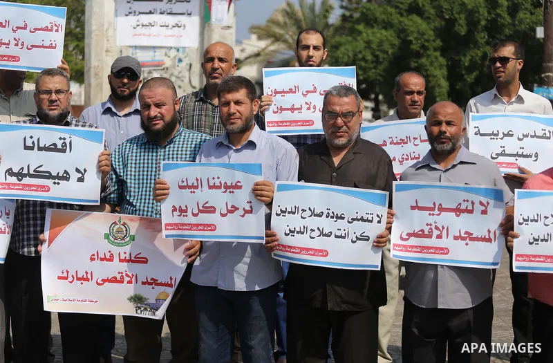 Palestinians take part in a protest against Israel's newly-installed security measures at the entrance to the al-Aqsa mosque compound, in Gaza city on July 27, 2017. Photo by Mohammed Asad
