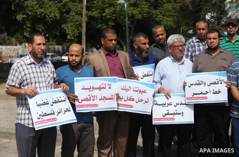 Palestinians take part in a protest against Israel's newly-installed security measures at the entrance to the al-Aqsa mosque compound, in Gaza city on July 27, 2017. Photo by Mohammed Asad