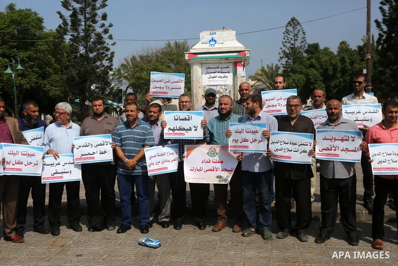 Palestinians take part in a protest against Israel's newly-installed security measures at the entrance to the al-Aqsa mosque compound, in Gaza city on July 27, 2017. Photo by Mohammed Asad