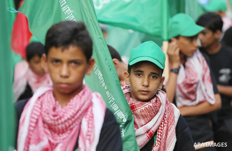 Palestinian youths take part during a rally organized by the Hamas movement in Gaza City on July 27, 2017. Thousands of Muslims flocked to a major Jerusalem shrine Thursday for the first organized prayers at the site in...