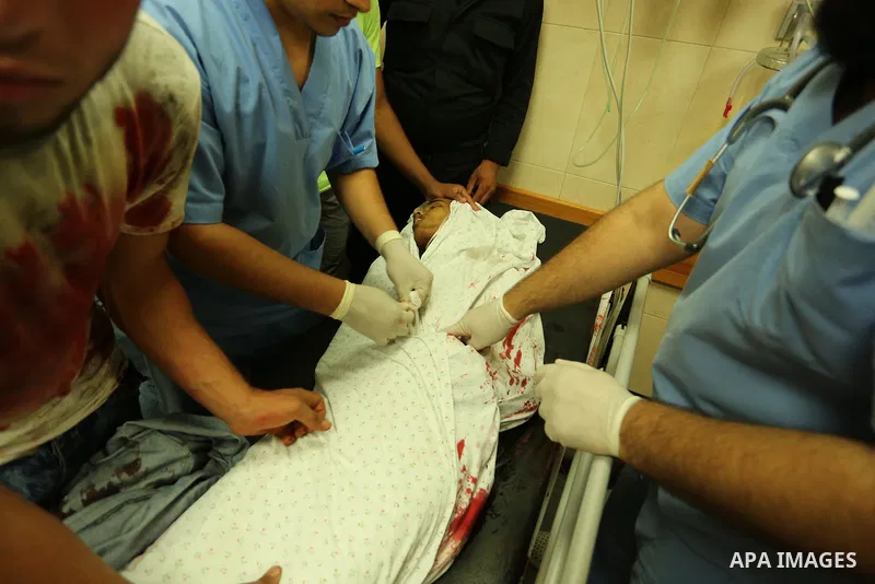 Relatives of a 16-year-old Palestinian, who was reportedly killed in clashes with the Israeli army along the Gaza border, view his body at a hospital in Deir al-Balah in the central Gaza strip on July 28, 2017. Photo by...