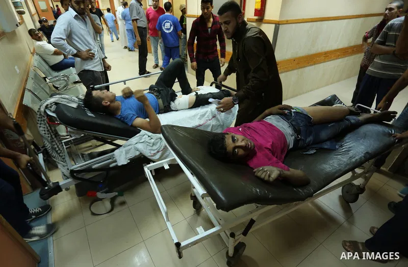Injured Palestinian protesters, who were wounded during clashes with the Israeli army along the Gaza border, recieves treatment at a hospital in Deir al-Balah in the central Gaza strip on July 28, 2017. Photo by Ashraf A...