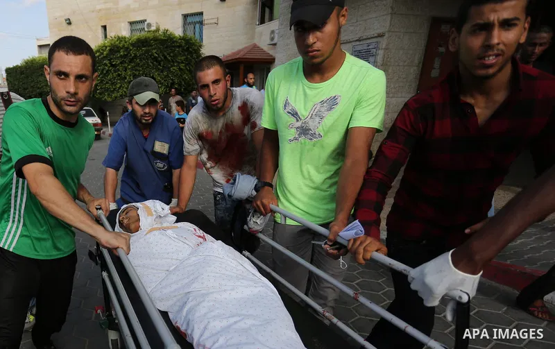 Relatives of a 16-year-old Palestinian, who was reportedly killed in clashes with the Israeli army along the Gaza border, view his body at a hospital in Deir al-Balah in the central Gaza strip on July 28, 2017. Photo by...