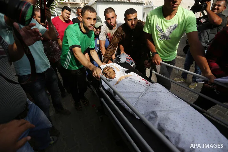 Relatives of a 16-year-old Palestinian, who was reportedly killed in clashes with the Israeli army along the Gaza border, view his body at a hospital in Deir al-Balah in the central Gaza strip on July 28, 2017. Photo by...