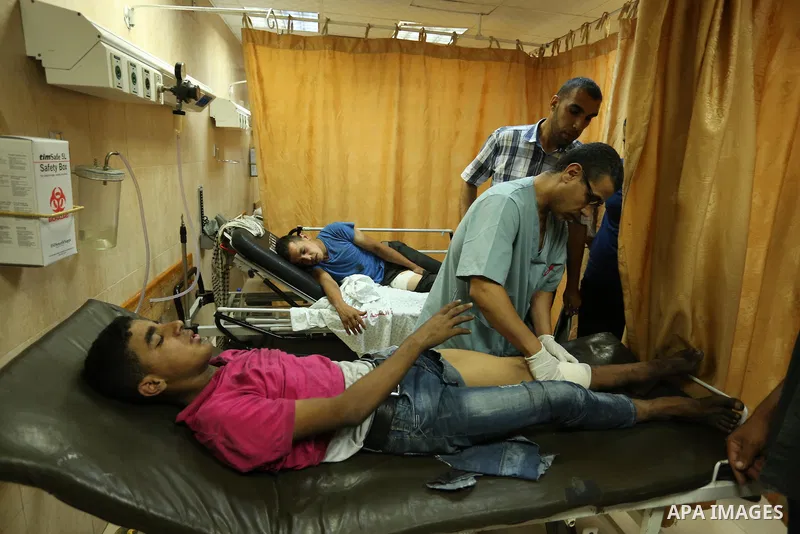 Injured Palestinian protesters, who were wounded during clashes with the Israeli army along the Gaza border, recieves treatment at a hospital in Deir al-Balah in the central Gaza strip on July 28, 2017. Photo by Ashraf A...