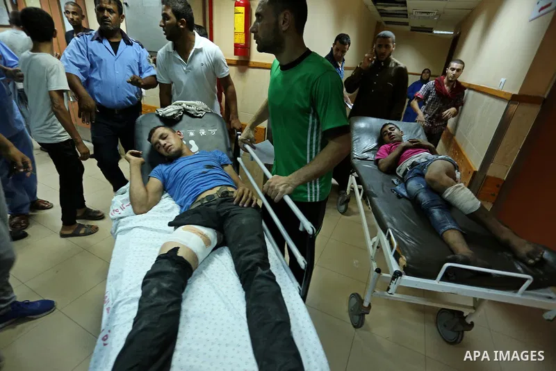 Injured Palestinian protesters, who were wounded during clashes with the Israeli army along the Gaza border, recieves treatment at a hospital in Deir al-Balah in the central Gaza strip on July 28, 2017. Photo by Ashraf A...