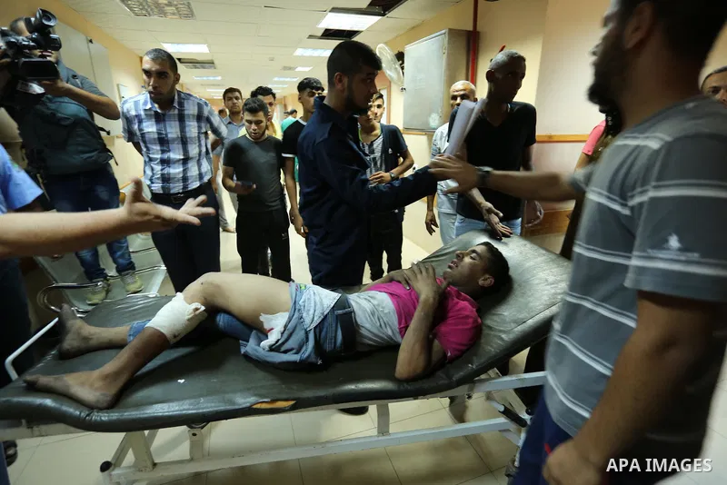 Injured Palestinian protesters, who were wounded during clashes with the Israeli army along the Gaza border, recieves treatment at a hospital in Deir al-Balah in the central Gaza strip on July 28, 2017. Photo by Ashraf A...