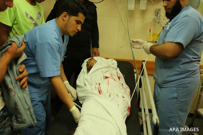 Relatives of a 16-year-old Palestinian, who was reportedly killed in clashes with the Israeli army along the Gaza border, view his body at a hospital in Deir al-Balah in the central Gaza strip on July 28, 2017. Photo by...