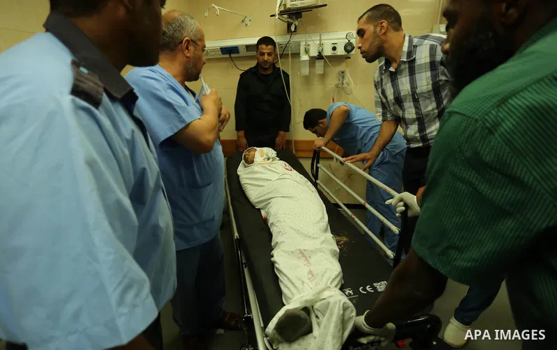 Relatives of a 16-year-old Palestinian, who was reportedly killed in clashes with the Israeli army along the Gaza border, view his body at a hospital in Deir al-Balah in the central Gaza strip on July 28, 2017. Photo by...
